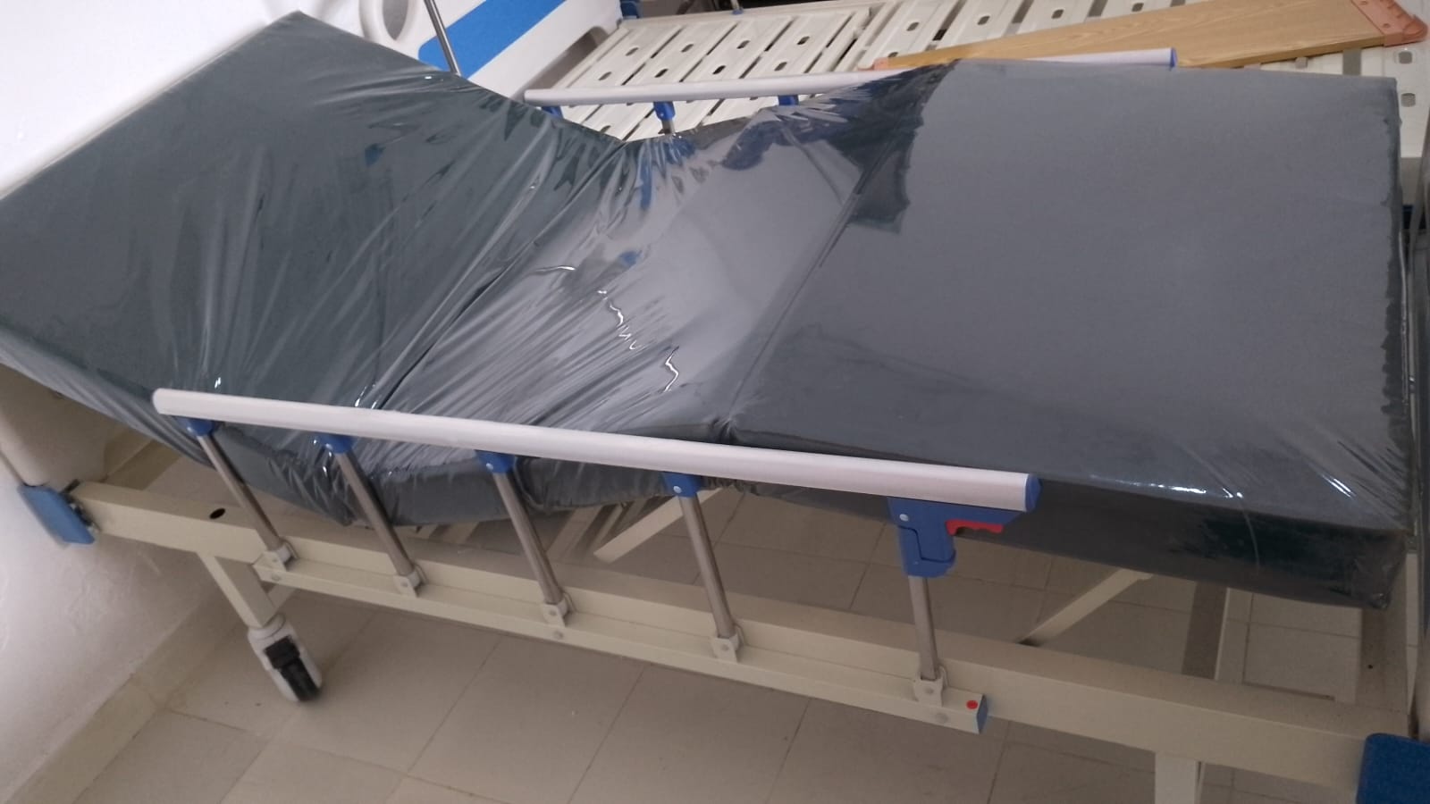 The Two Crank ABS Hospital Bed with Over-Bed Table is a versatile and practical solution designed for both clinical and home care environments. Featuring two manual cranks, it allows for independent adjustment of both the backrest and the knee-rest/leg section, maximizing patient comfort, circulation, and ease of care. The included over-bed table provides a convenient, adjustable surface for meals, reading, or personal items, enhancing daily living for bedridden patients.Key FeaturesDual Crank System: Two smooth manual hand cranks allow caregivers to easily adjust the backrest (0° to 75°) and the knee-rest (0° to 40°) independently.Over-Bed Table Included: A height-adjustable, sturdy over-bed table slides conveniently over the bed, perfect for dining, medications, or laptop use.Premium ABS Panels: Detachable ABS head and footboards that are impact-resistant, durable, and easy to sanitize for optimal hygiene.Heavy-Duty Steel Frame: Robust, epoxy-coated steel construction designed for stability, longevity, and high weight capacity.Mobility Castors: 360-degree swivel castors equipped with reliable locking brakes for safe, effortless transport and secure stationary positioning.Collapsible Guardrails: Foldable aluminum alloy or ABS side rails to prevent accidental falls and ensure patient safety.Accessories Included: Comes standard with pre-drilled sockets for an adjustable IV drip pole.Technical SpecificationsFunctions: 2-function (Backrest and knee-rest adjustment)Backrest Tilt: $0^\circ \text{ to } 75^\circ$Knee-rest Tilt: $0^\circ \text{ to } 40^\circ$Weight Capacity: 150 kg – 200 kgFramework: Epoxy-coated steelCastors: Approx. 125mm (5-inch) silent castors with brakesTable Features: Adjustable height, durable easy-to-clean surface The Two Crank ABS Hospital Bed with Over-Bed Table is a versatile and practical solution designed for both clinical and home care environments. Featuring two manual cranks, it allows for independent adjustment of both the backrest and the knee-rest/leg section, maximizing patient comfort, circulation, and ease of care. The included over-bed table provides a convenient, adjustable surface for meals, reading, or personal items, enhancing daily living for bedridden patients.Key FeaturesDual Crank System: Two smooth manual hand cranks allow caregivers to easily adjust the backrest (0° to 75°) and the knee-rest (0° to 40°) independently.Over-Bed Table Included: A height-adjustable, sturdy over-bed table slides conveniently over the bed, perfect for dining, medications, or laptop use.Premium ABS Panels: Detachable ABS head and footboards that are impact-resistant, durable, and easy to sanitize for optimal hygiene.Heavy-Duty Steel Frame: Robust, epoxy-coated steel construction designed for stability, longevity, and high weight capacity.Mobility Castors: 360-degree swivel castors equipped with reliable locking brakes for safe, effortless transport and secure stationary positioning.Collapsible Guardrails: Foldable aluminum alloy or ABS side rails to prevent accidental falls and ensure patient safety.Accessories Included: Comes standard with pre-drilled sockets for an adjustable IV drip pole.Technical SpecificationsFunctions: 2-function (Backrest and knee-rest adjustment)Backrest Tilt: $0^\circ \text{ to } 75^\circ$Knee-rest Tilt: $0^\circ \text{ to } 40^\circ$Weight Capacity: 150 kg – 200 kgFramework: Epoxy-coated steelCastors: Approx. 125mm (5-inch) silent castors with brakesTable Features: Adjustable height, durable easy-to-clean surface